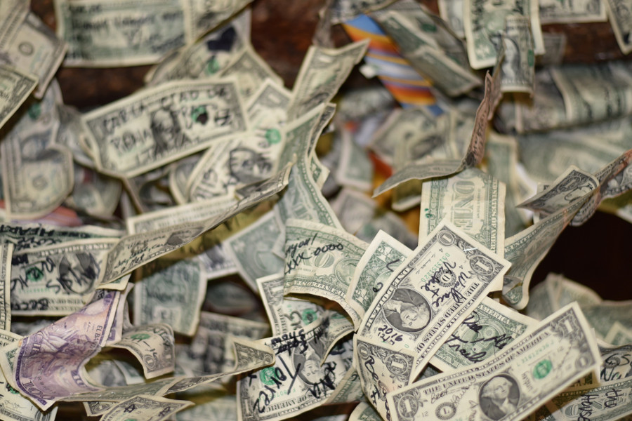 Pile of one dollar bills with messages on them.